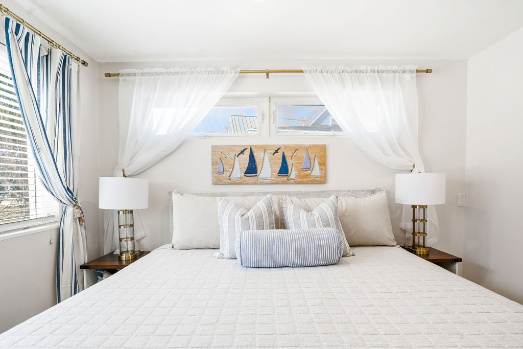 Drift into comfort in this bright and peaceful bedroom at The Yacht Club.