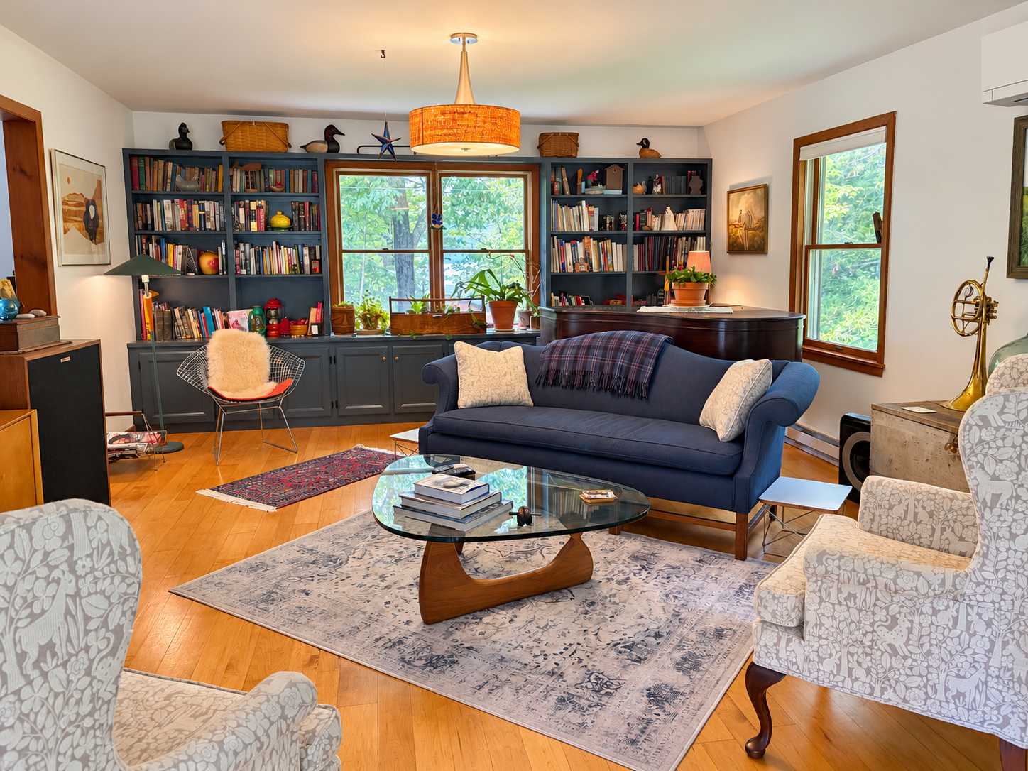 Living room with comfortable seating and a piano.