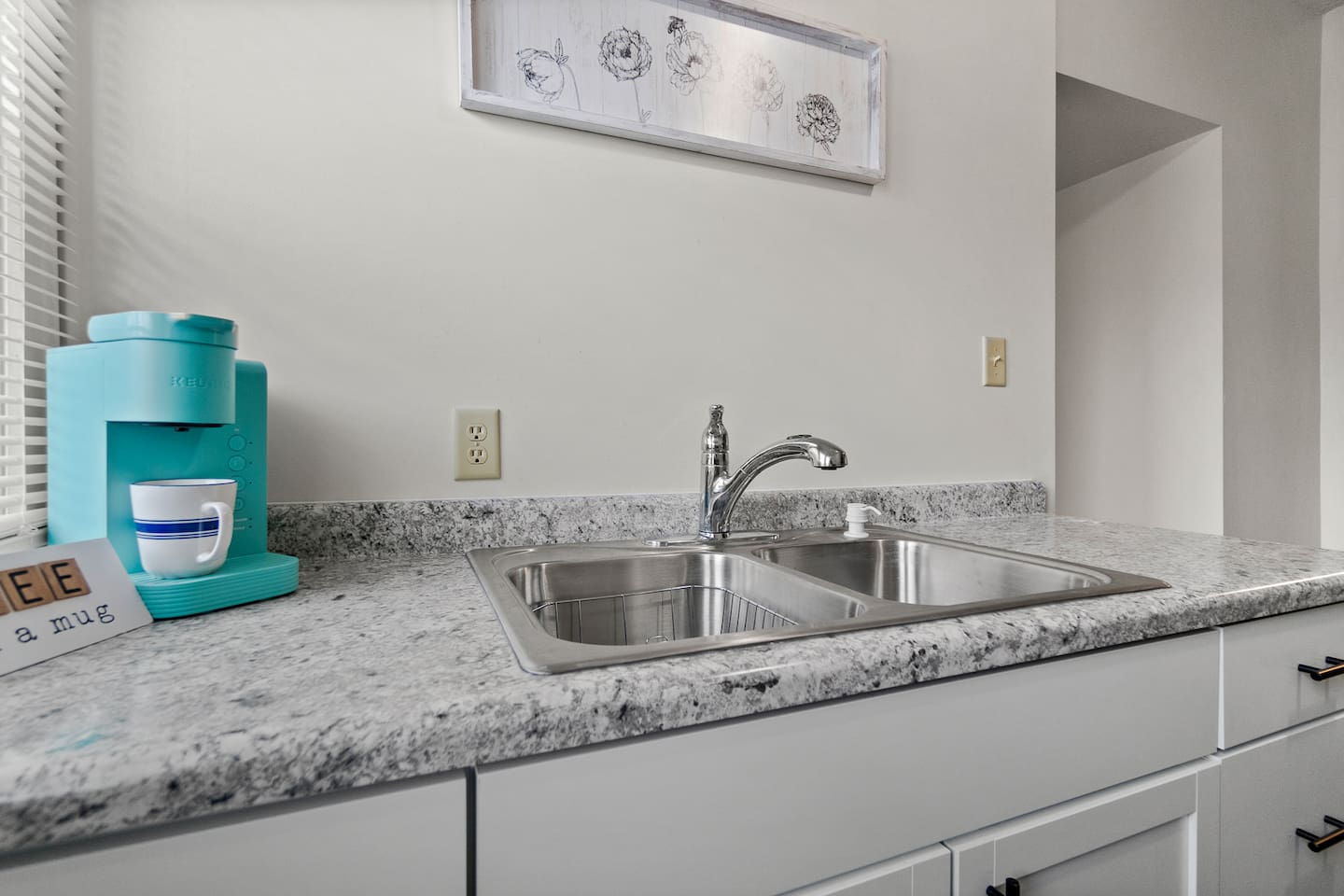 Modern full kitchen featuring a sleek sink with faucet, a stylish coffee maker, and elegant granite countertops—designed for functionality and style, offering a perfect space for cooking, brewing coffee, and enjoying a contemporary kitchen experience