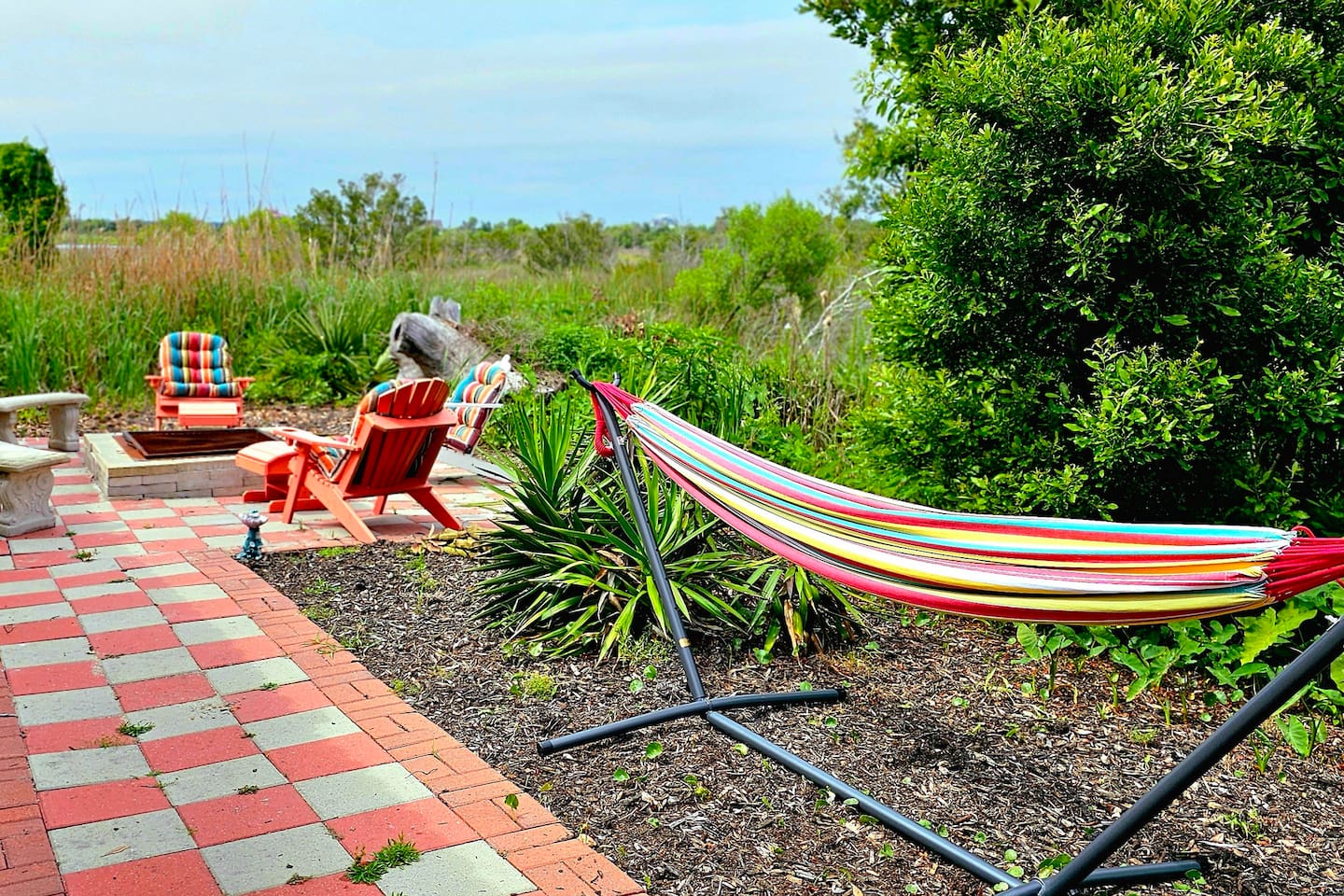 backyard overlooking the Marsh and sound. firepit, lounge chairs, and hammock 