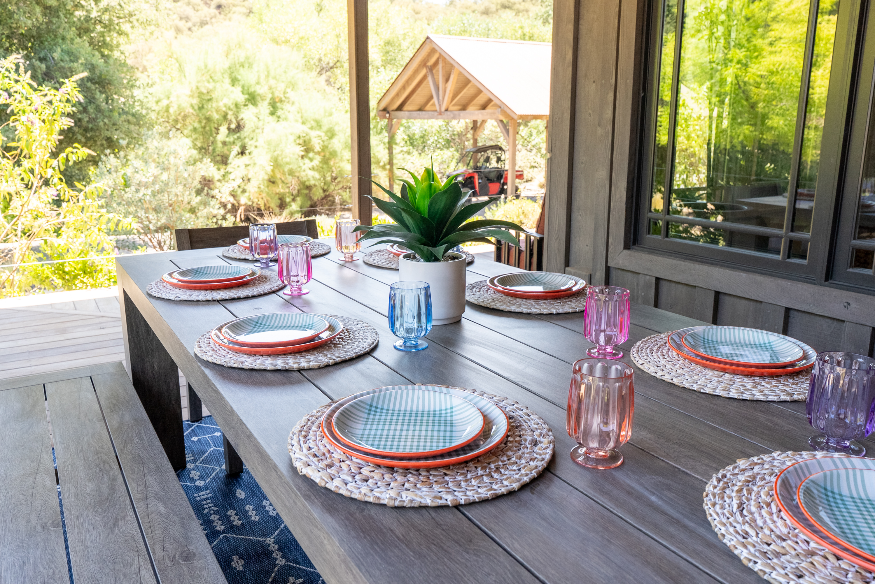Covered patio dining surrounded by oak tree views