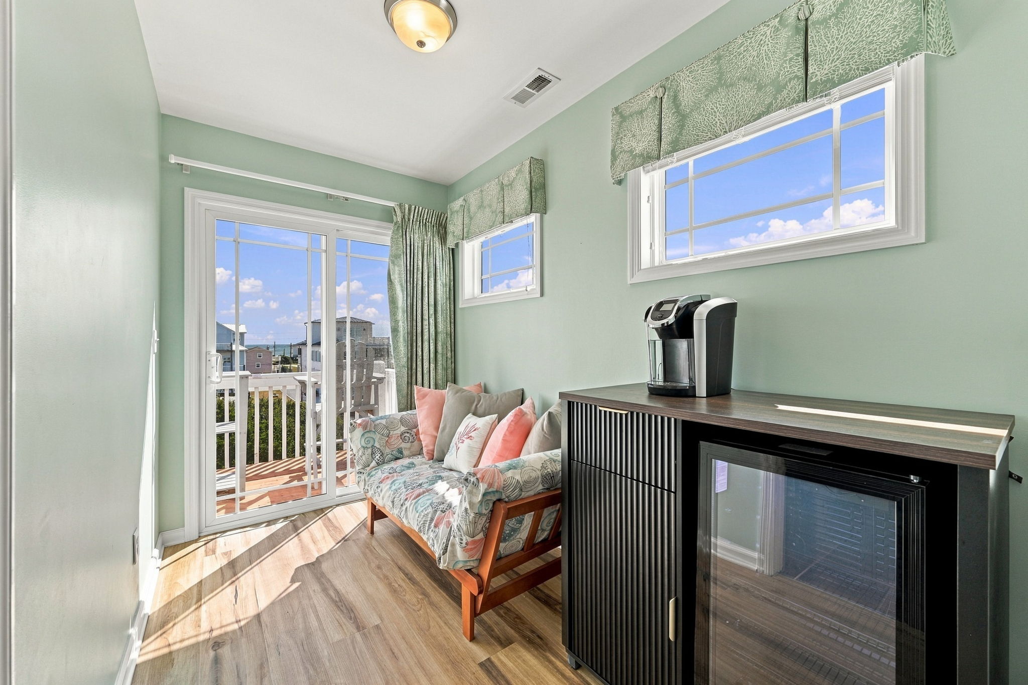 Cozy sitting nook with a convenient coffee station, mini fridge, and access to the balcony