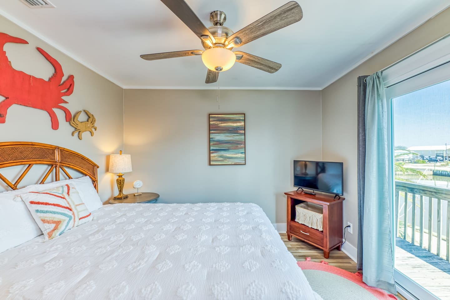 Bedroom Retreat: Bright space with nautical decor, TV, and views for a refreshing getaway!