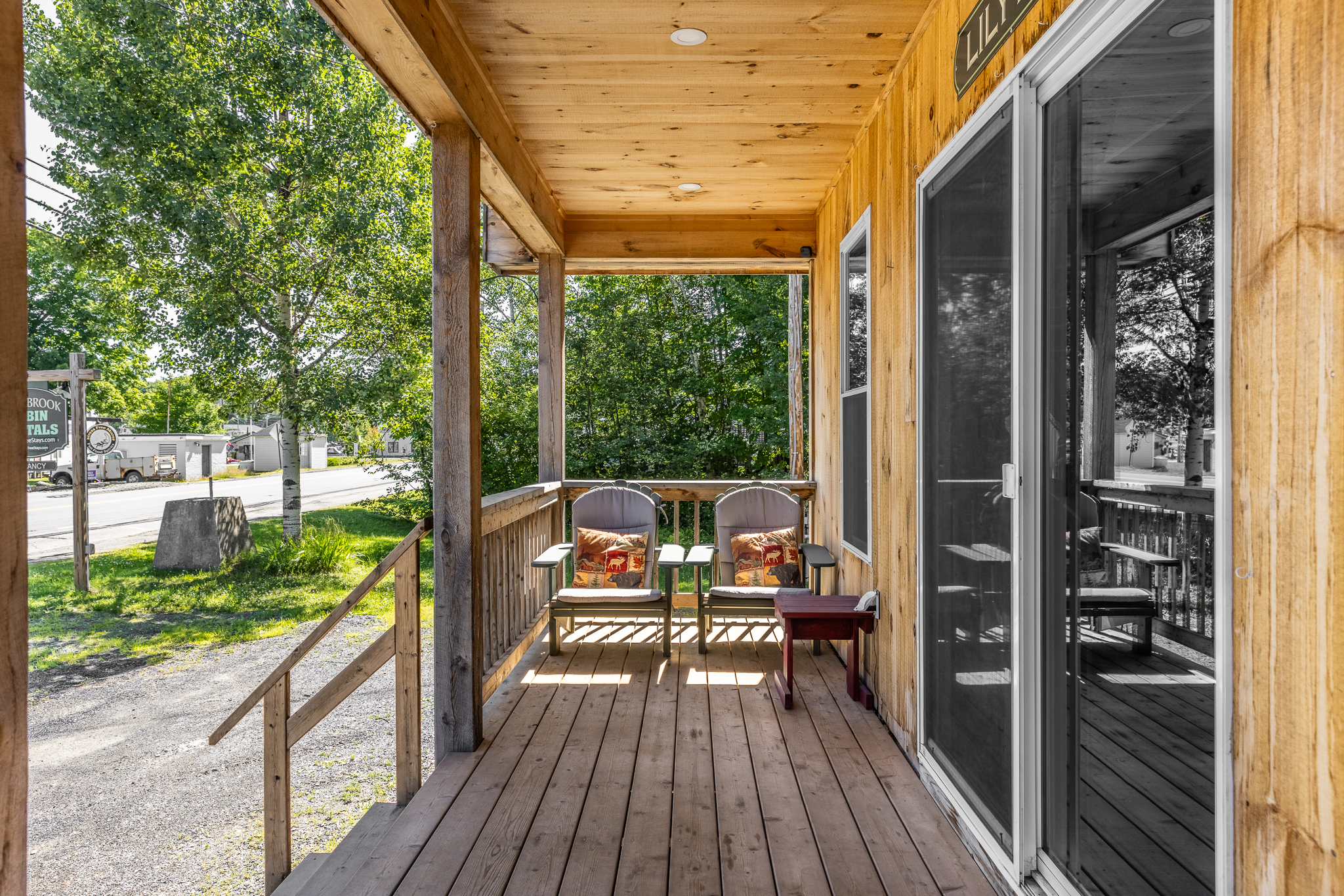 Front porch with Adirondack chairs to relax with access to restaurants and shops