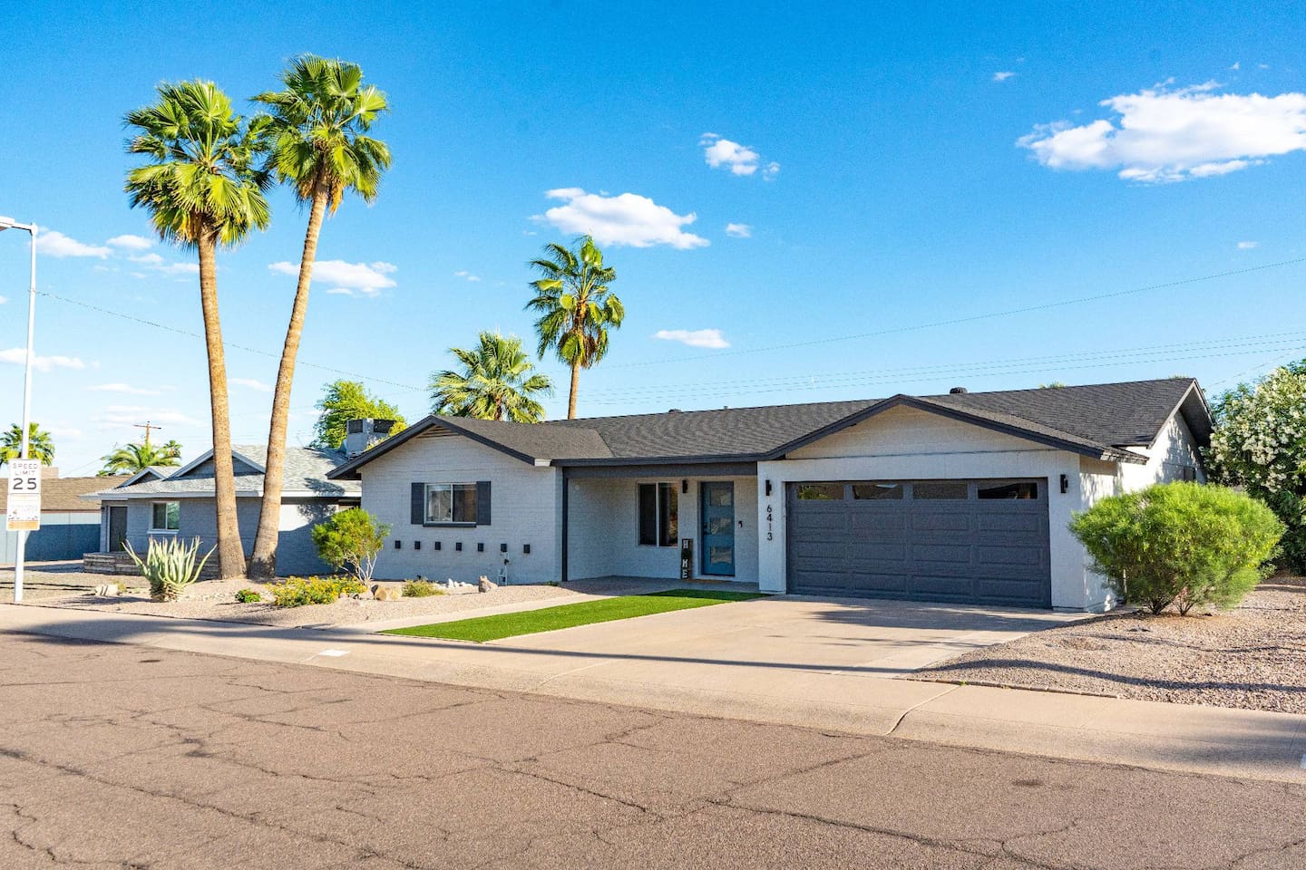 Modern desert retreat with private driveway, garage, and a warm, welcoming entry.