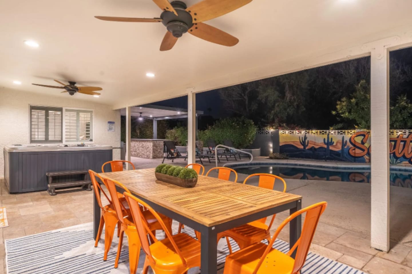 Seating for eight under the stars, steps from the pool and hot tub — dinner here comes with its own view.