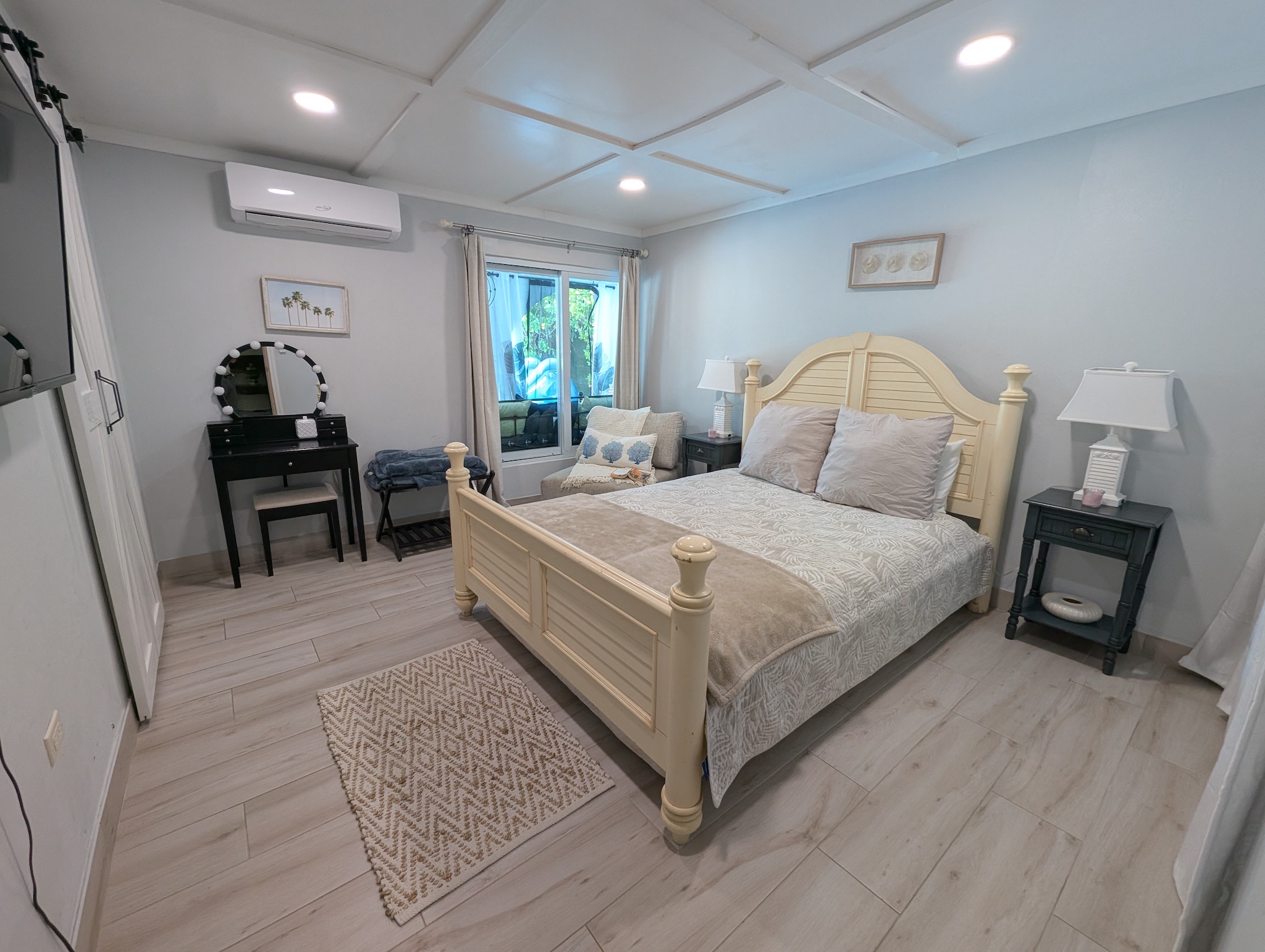 Dedicated makeup vanity table and seating area inside the queen guest bedroom at Villa Coral.
