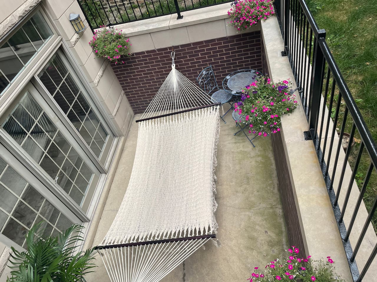 Relaxing outdoor patio with hammock for peaceful afternoon break.