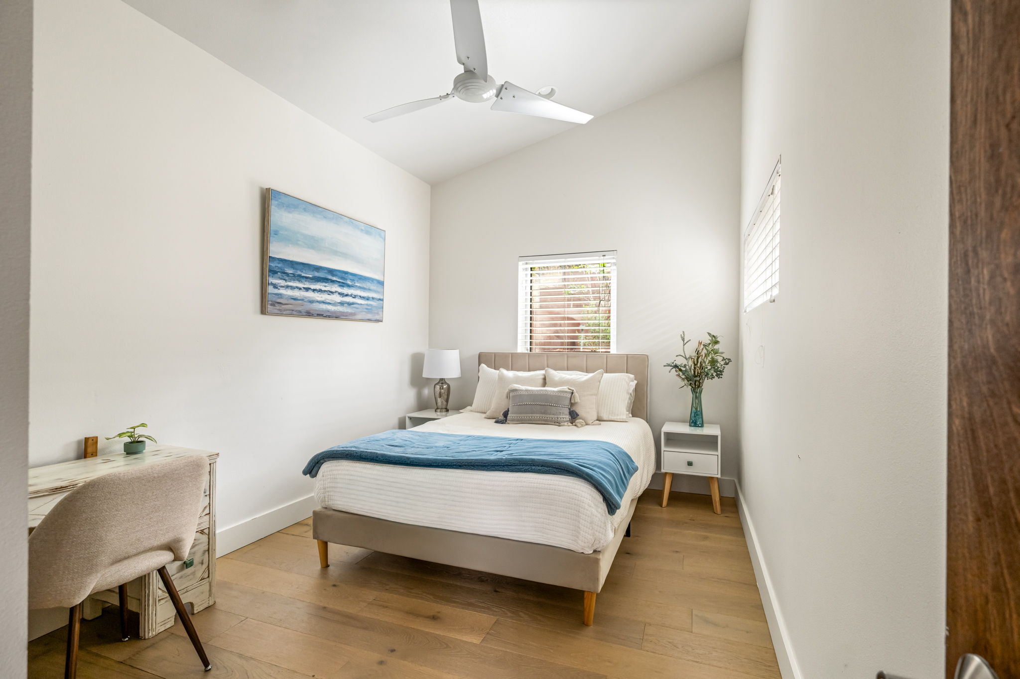Quiet guest bedroom with a comfortable bed and ceiling fan
