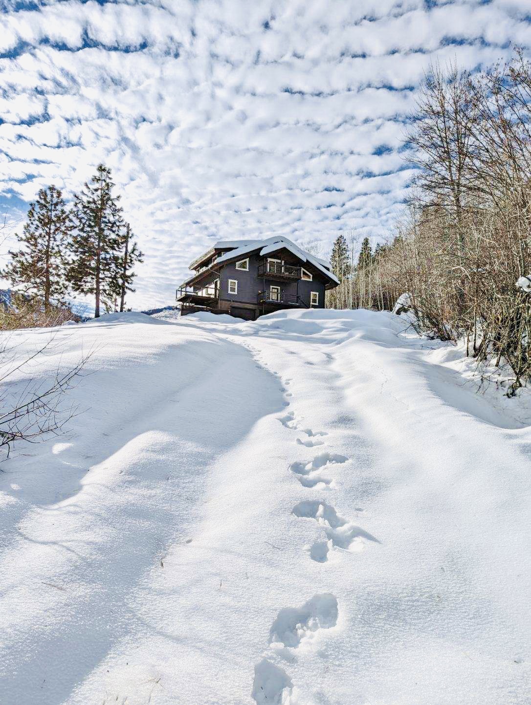 Driveway up to the home from the open barn/garage - we do our best to have the driveway plowed for guests with a 4 inch rule of thumb with our snowplow vendor
