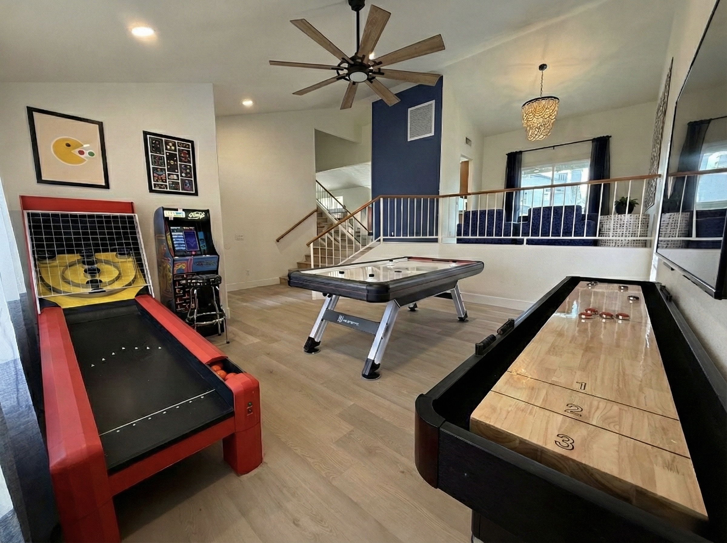 Game room with full-size air hockey, shuffleboard, skee ball, Multi-Game Standing Ms PacMan Machine, & Smart TV