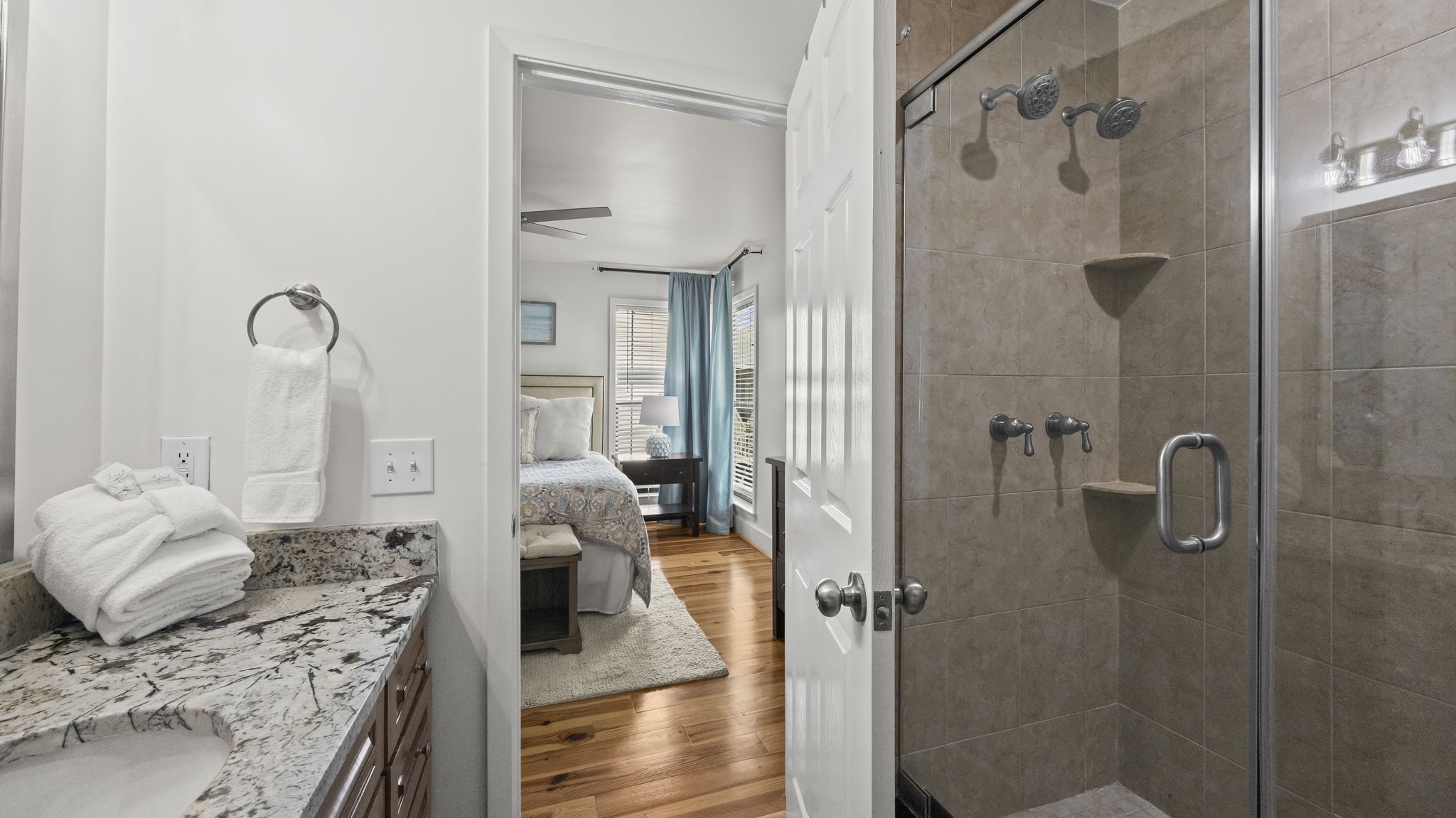 Indulge in the luxurious master en suite of our Cotton Bayou condo, featuring dual shower heads for a spa-like experience. This private retreat complements the spacious master suite, offering ultimate relaxation after a day by the pool or on the water.