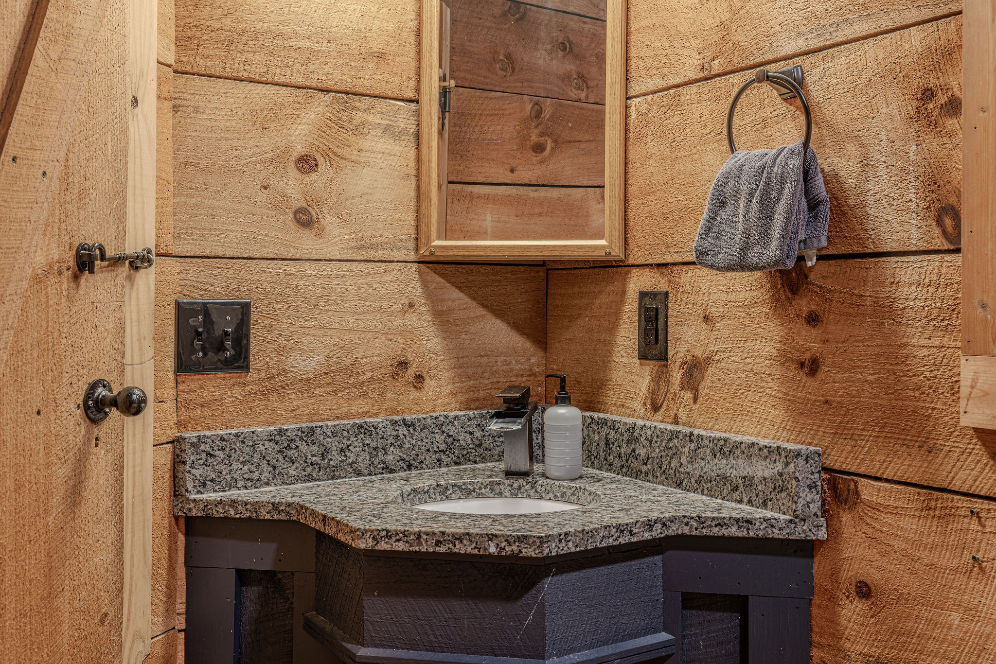 Granite vanity tucked right into the corner.