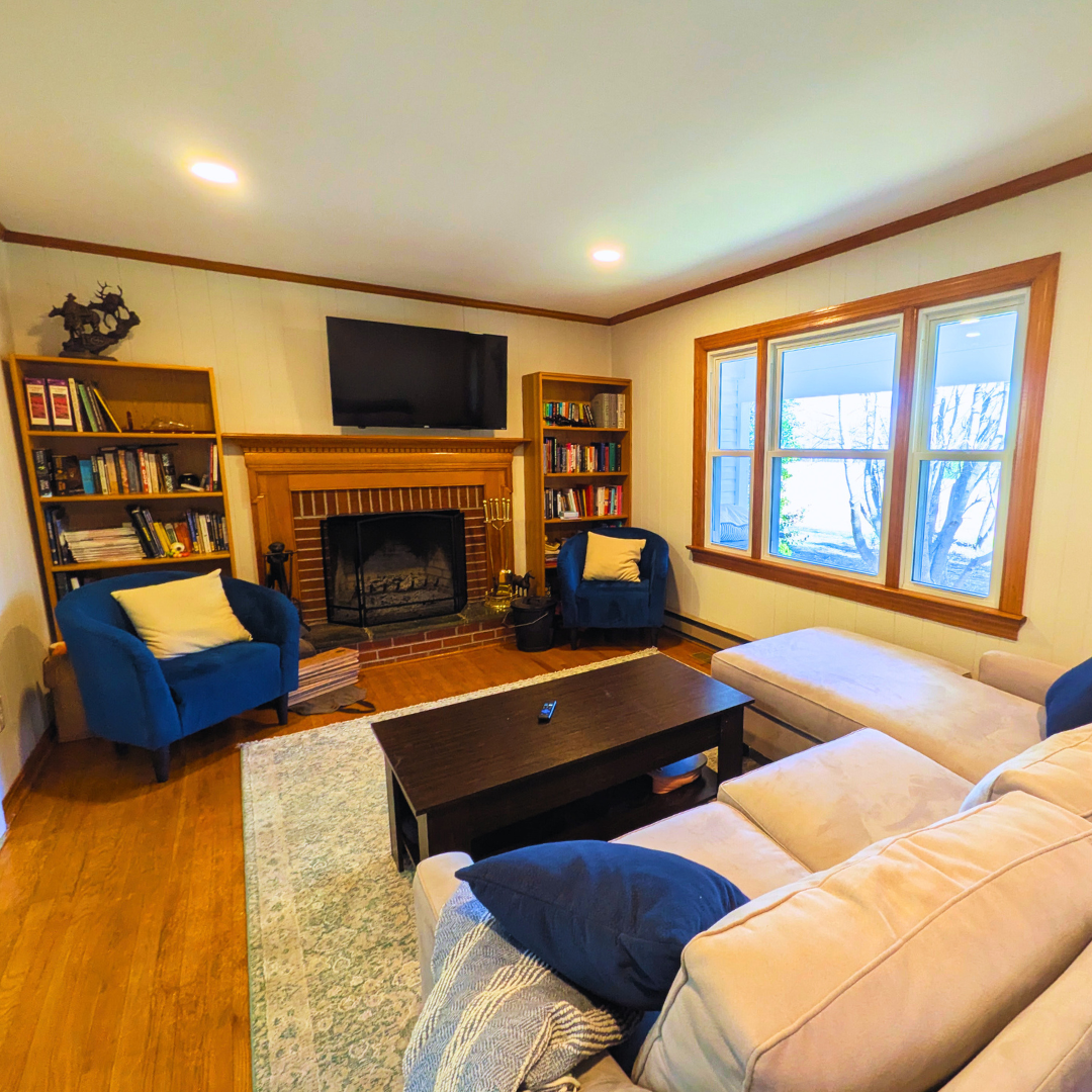 Modern comfort meets homey charm. This spacious living room is designed for relaxation, featuring comfortable seating, a smart TV, and a welcoming atmosphere.