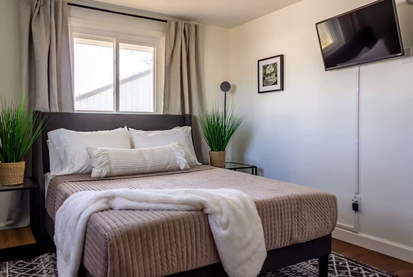 A plush throw at the foot of the bed invites you to curl up and stay awhile.