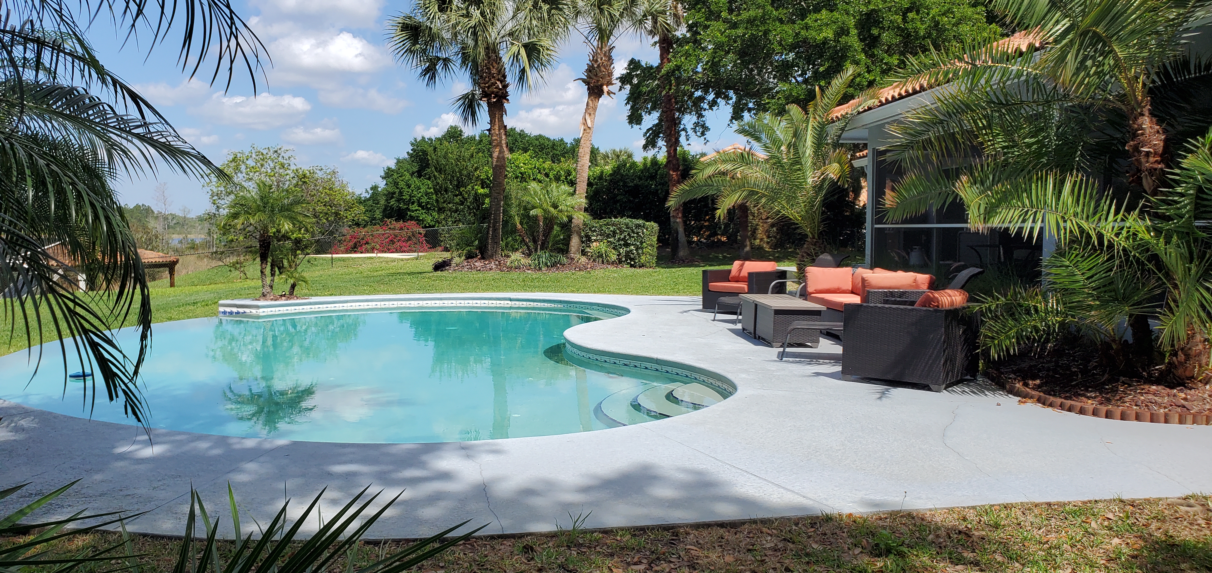 Sunset Cove pool, deck and comfortable outdoor seating