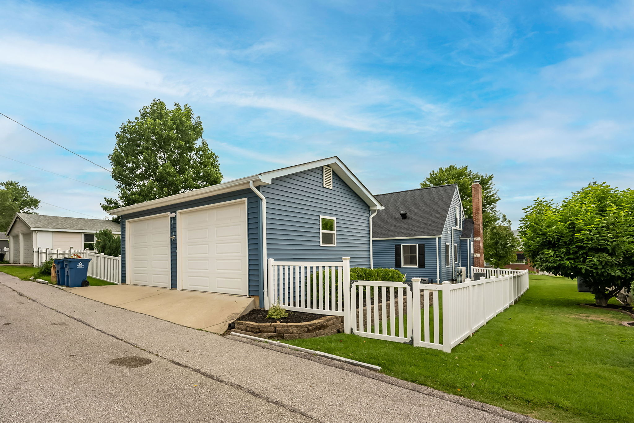 Private driveway and detached two-car garage provide convenient parking. Access is from the alley.