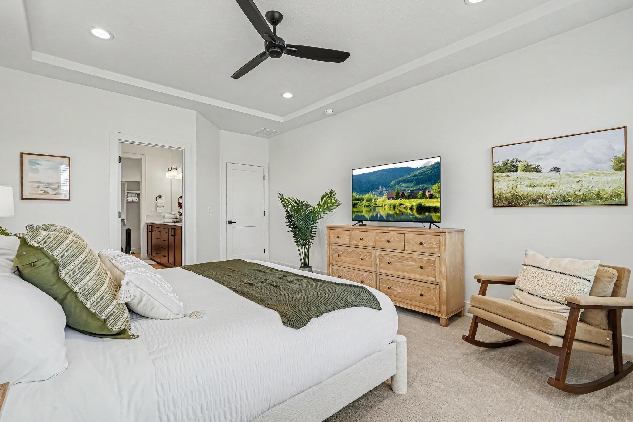 Enjoy a peaceful night’s sleep in the spacious master bedroom, complete with a California King bed and Smart TV.