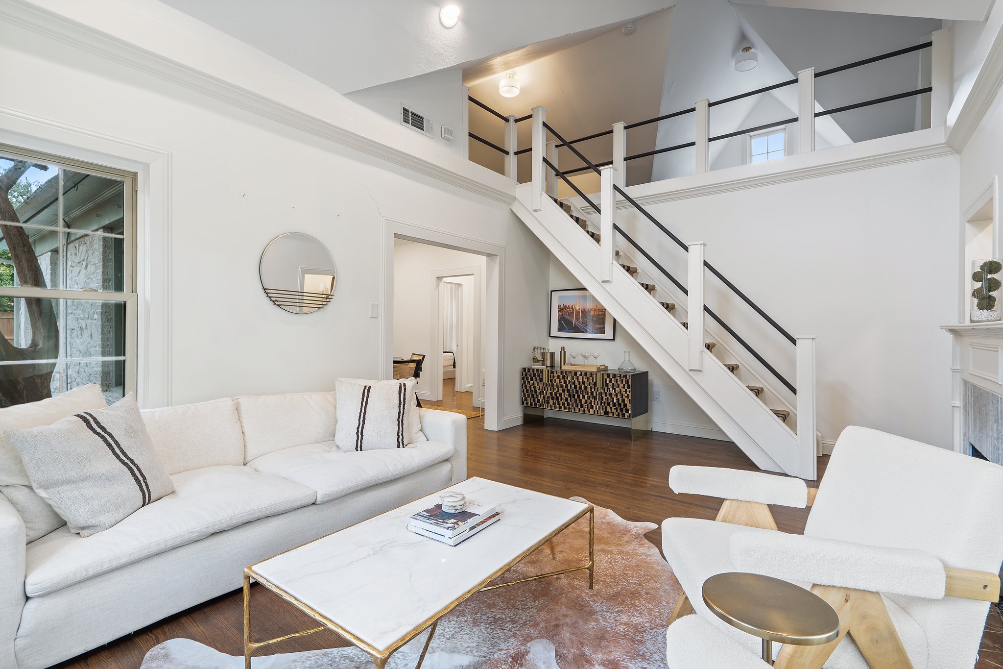 Open-concept living and dining flow with original 1929 architectural details, hardwood floors, and abundant natural light. Central AC and heat, high-speed Wi-Fi, and Ethernet connection throughout.