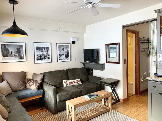 Living room area leading to bathroom & small room with bunkbeds.