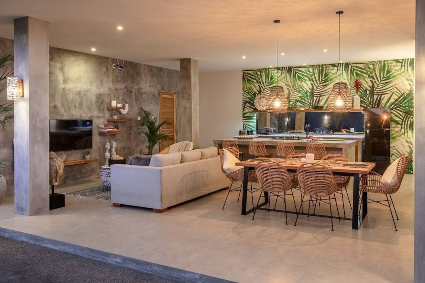 A spacious kitchen, dining, and living area, well-lit by natural daylight, inviting you to cook, read, or even watch television.
