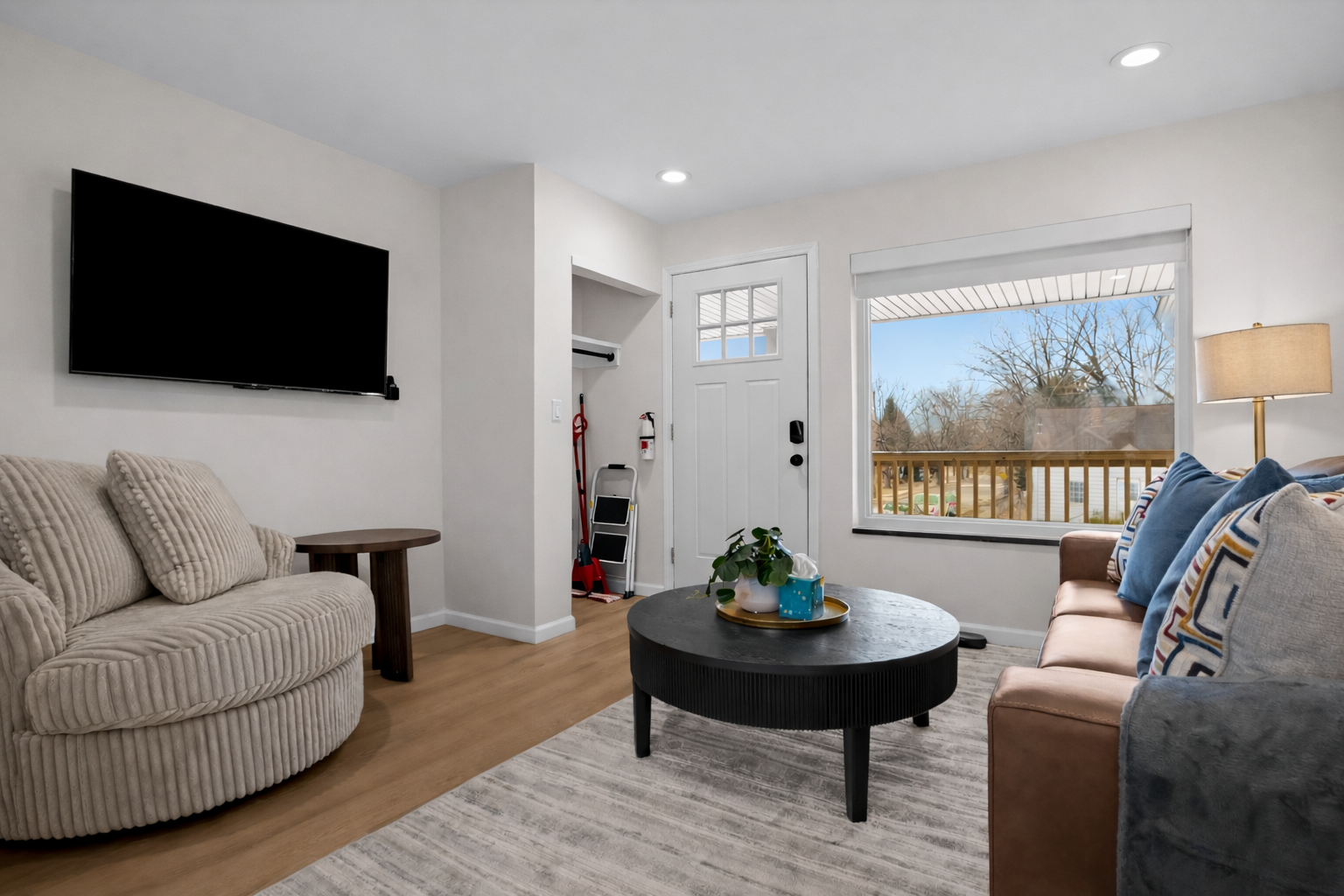 Bright, modern living room with comfy seating, smart TV, and natural light—perfect for relaxing, streaming your favorites, or enjoying a quiet morning in.