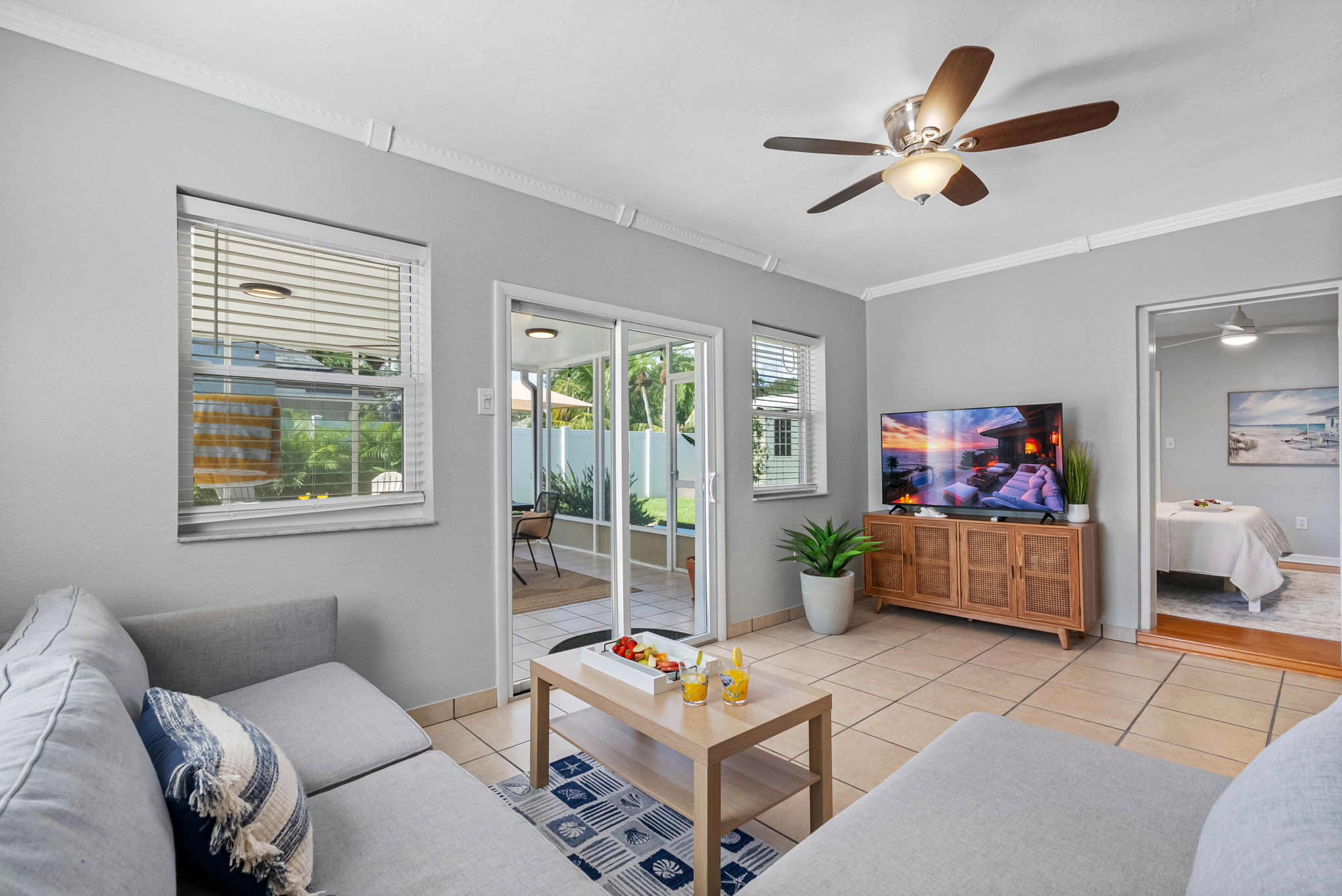 Your favorite streaming apps are just a click away on the large smart TV, surrounded by cozy armchairs and a deep, soft sofa.