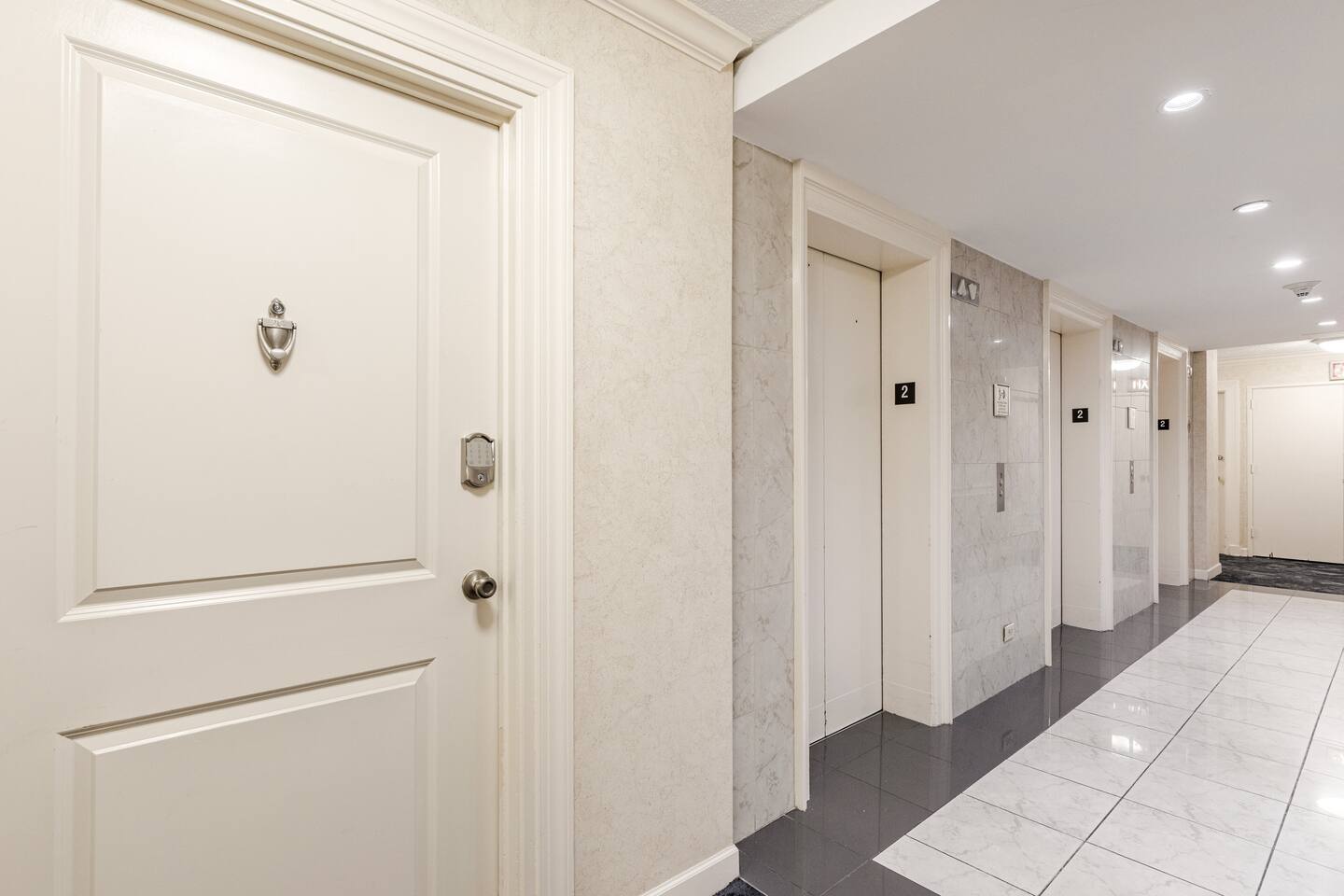 Clean, airy hallway connecting rooms w/ a bright, welcoming feel.