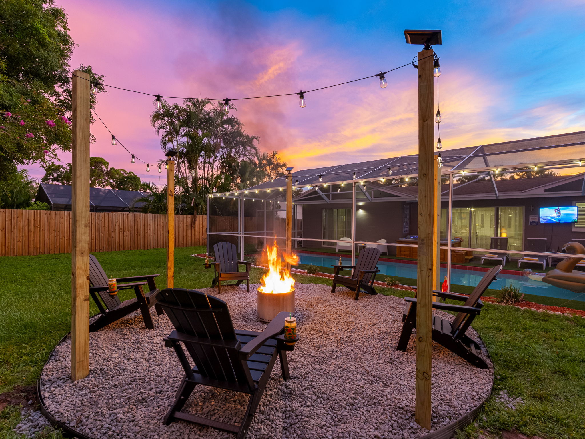 Gather around the glowing fire pit under string lights and a painted sky—perfect for toasting marshmallows and making memories.