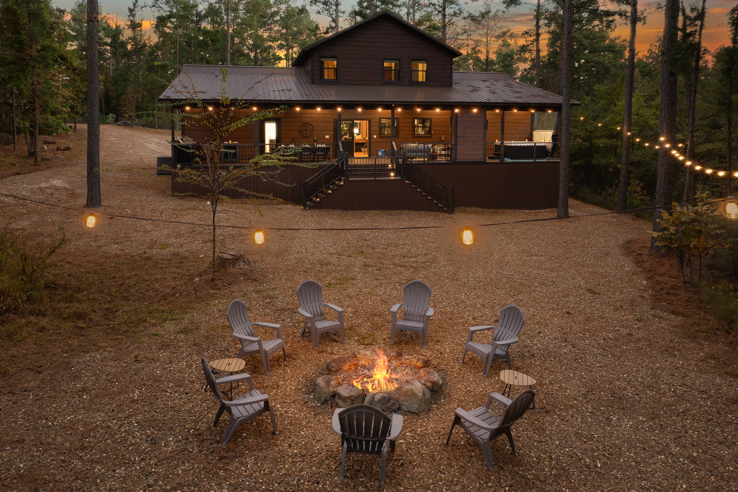 Evenings by the fire feel magical under the trees. This spacious gathering spot is made for slow conversations and s more filled nights.