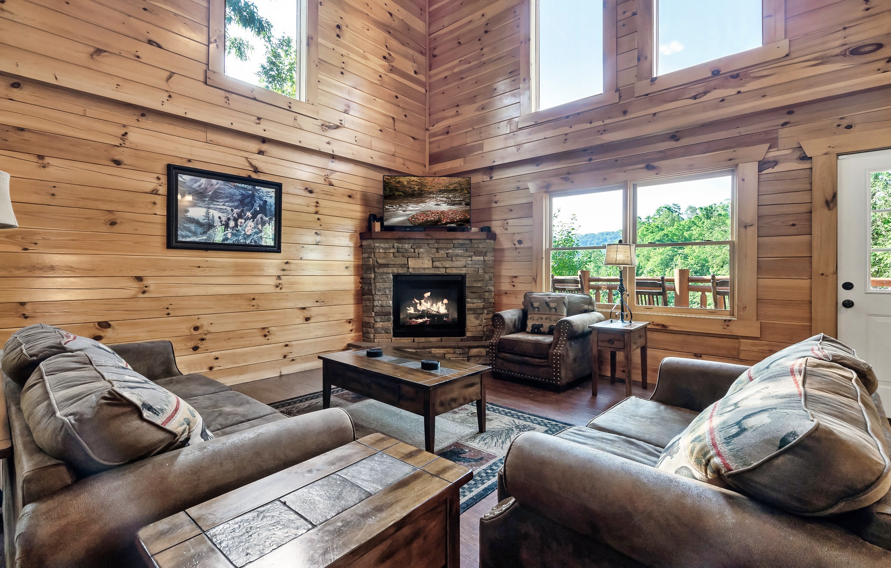 Sink into the soaring, sun drenched living room where vaulted ceilings and warm wood create instant cabin wow.