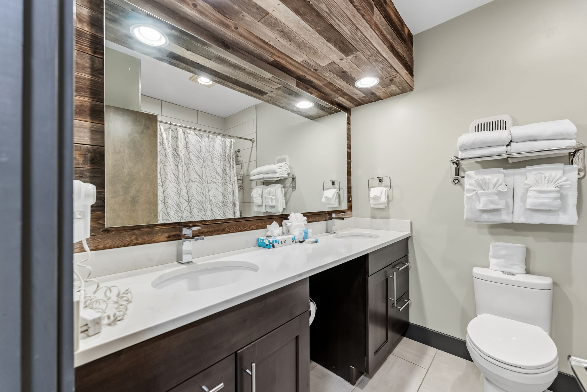 Full bathroom with two sinks, tub/shower