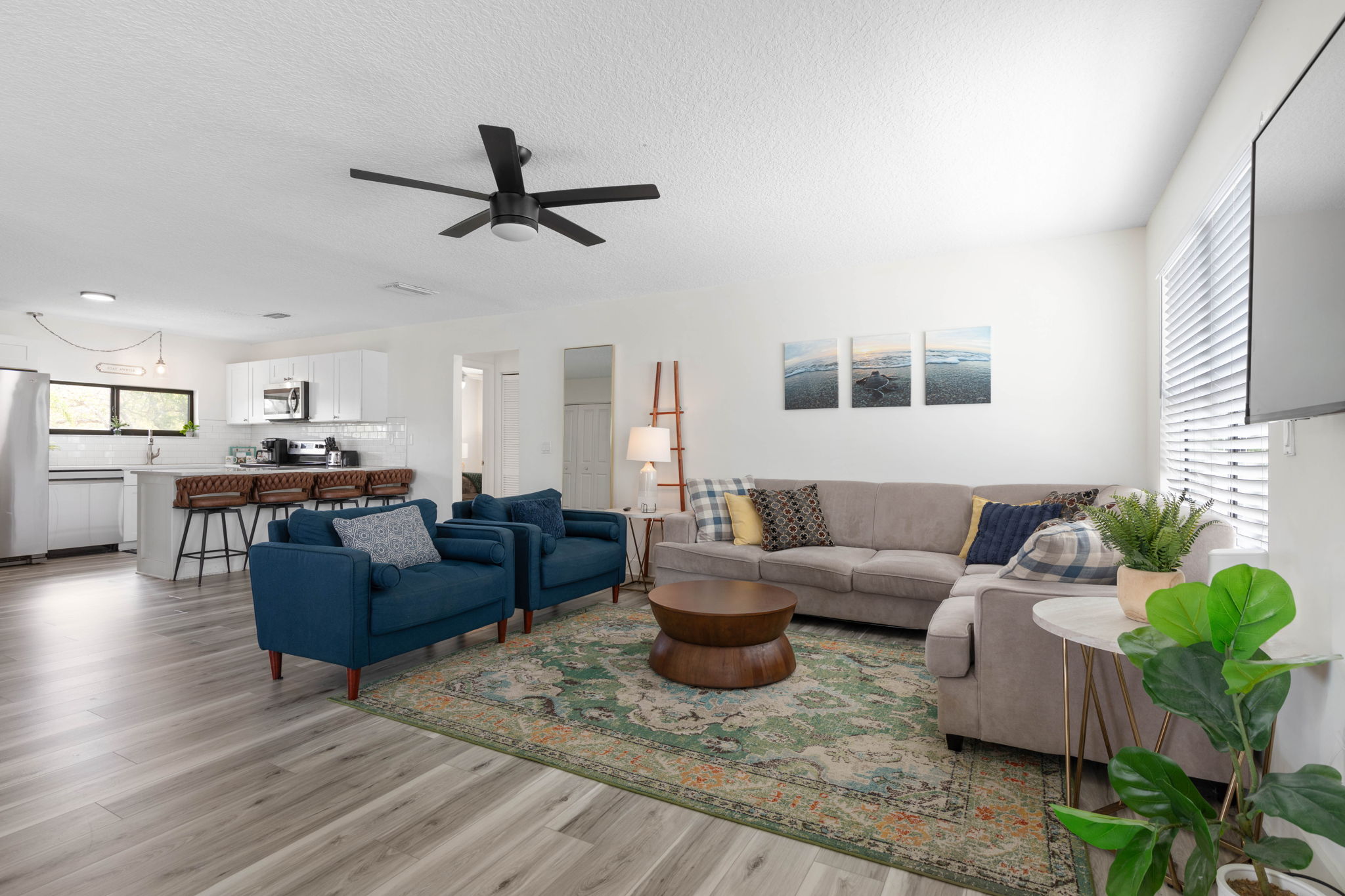 After a day in the sun, everyone gathers here—kids curled up for a movie, parents lingering over easy conversation, and the kitchen close enough for late-night snacks. It is the kind of open, welcoming space where family time feels effortless.