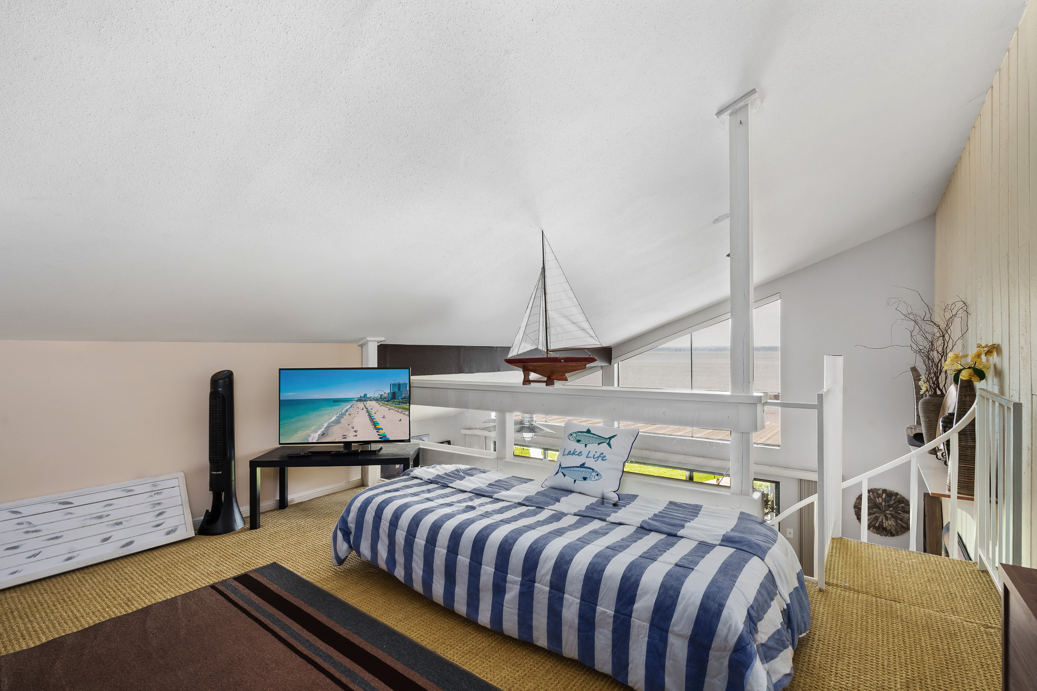 This airy loft exudes laid-back lake life with breezy views, coastal décor, and a cozy twin bed perfect for afternoon naps or unwinding with a movie. It’s the ultimate chill zone after a day on the water.