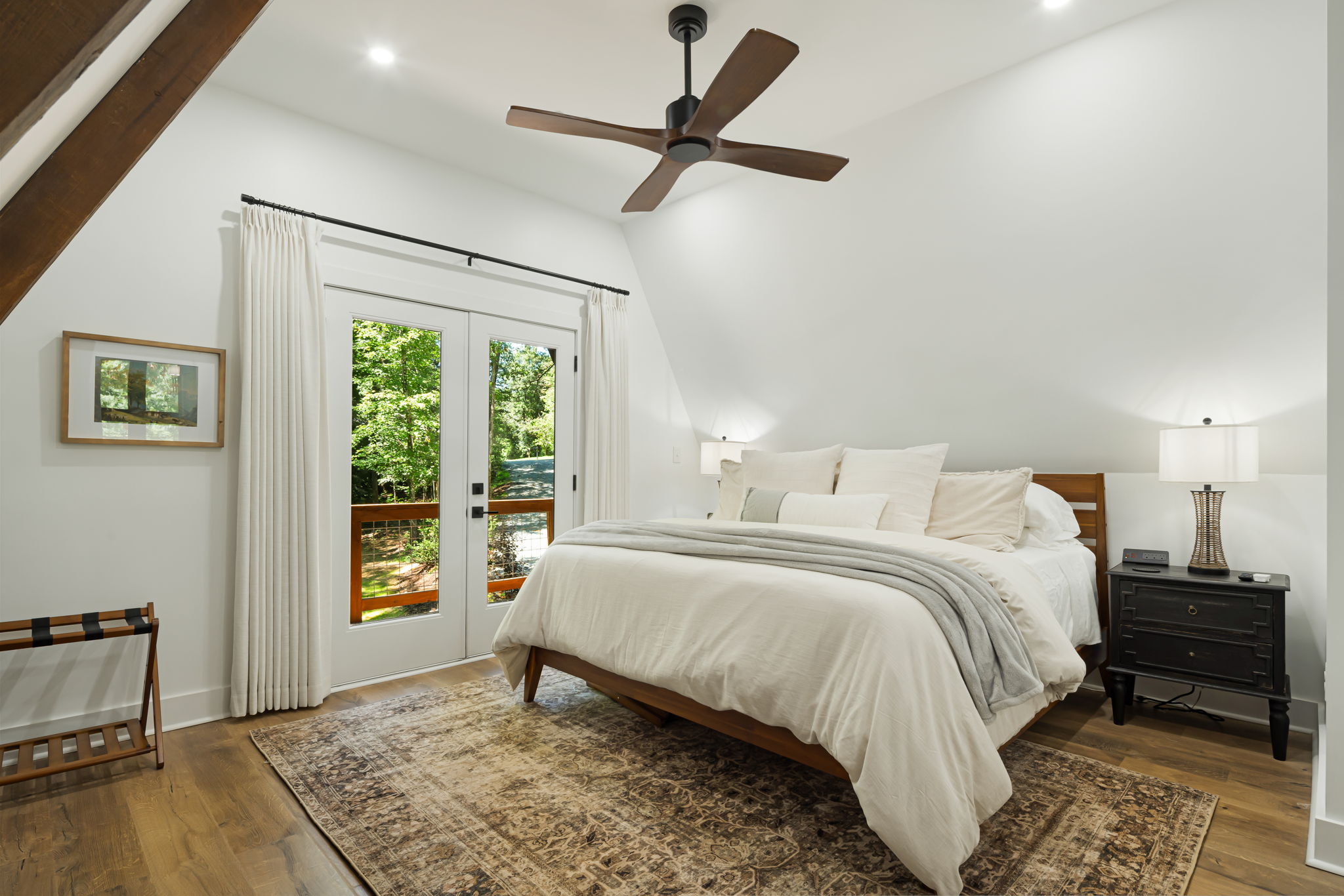 This bedroom is beautifully decorated and with a private balcony. Located on the second floor and accessible through the spiral staircase, this bedroom has a king size bed and a walk-in closet with hangers and shelf space, and a private ensuite bathroom.