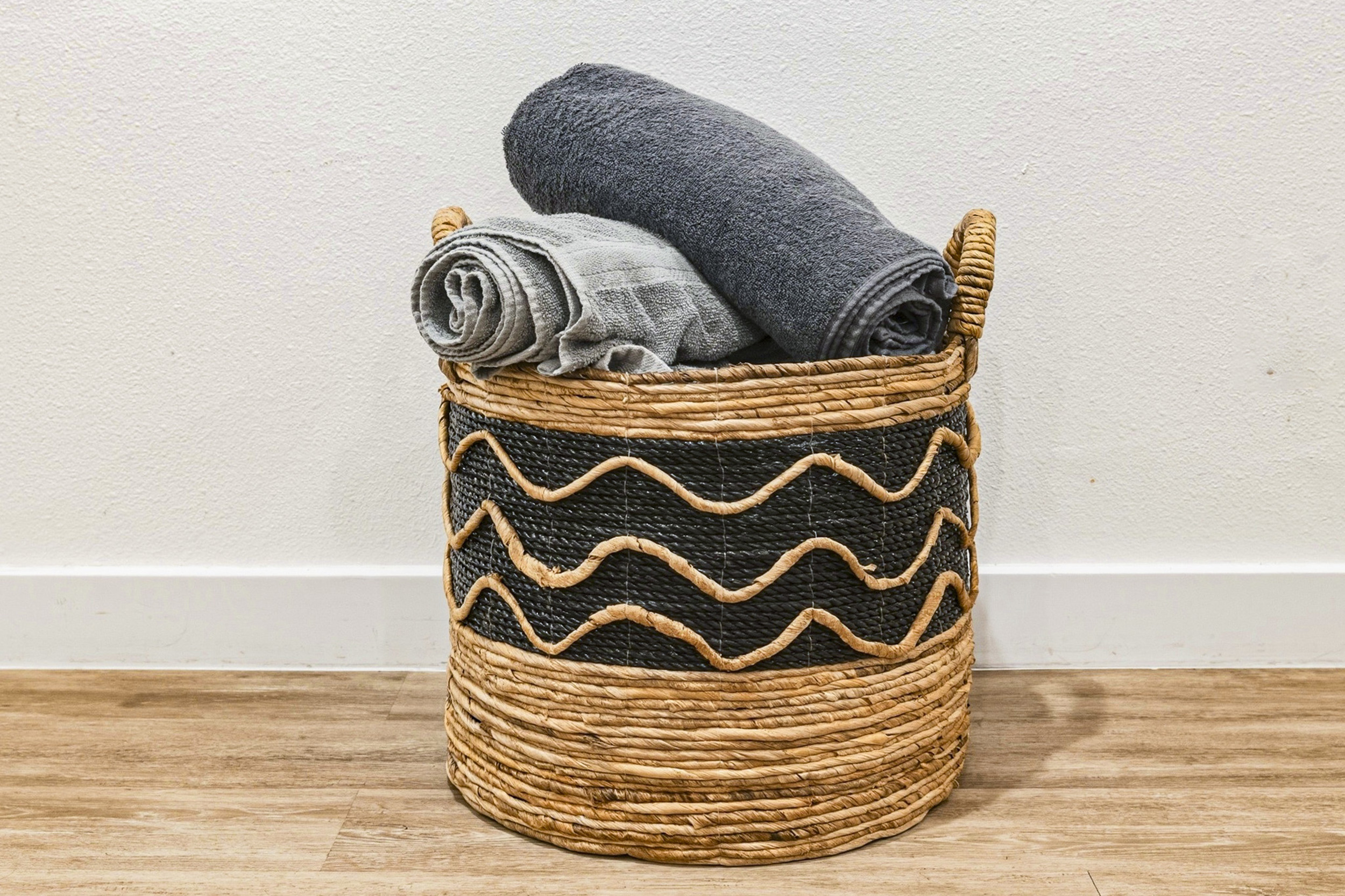 Stylish basket ready to hold your towels in a chic, organized retreat!