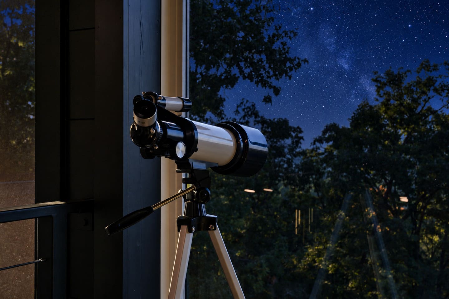 Telescope in the loft lounge, accessed by a ladder beside the upper-level fireplace.