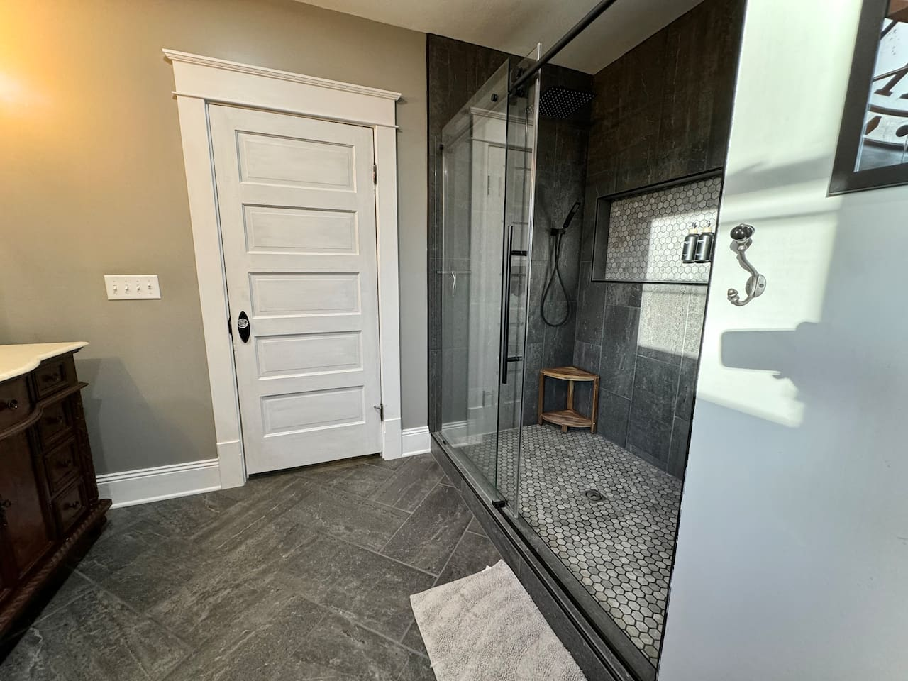 Shower with double rainfall shower heads and hand-helds in the Paris ensuite bathroom.