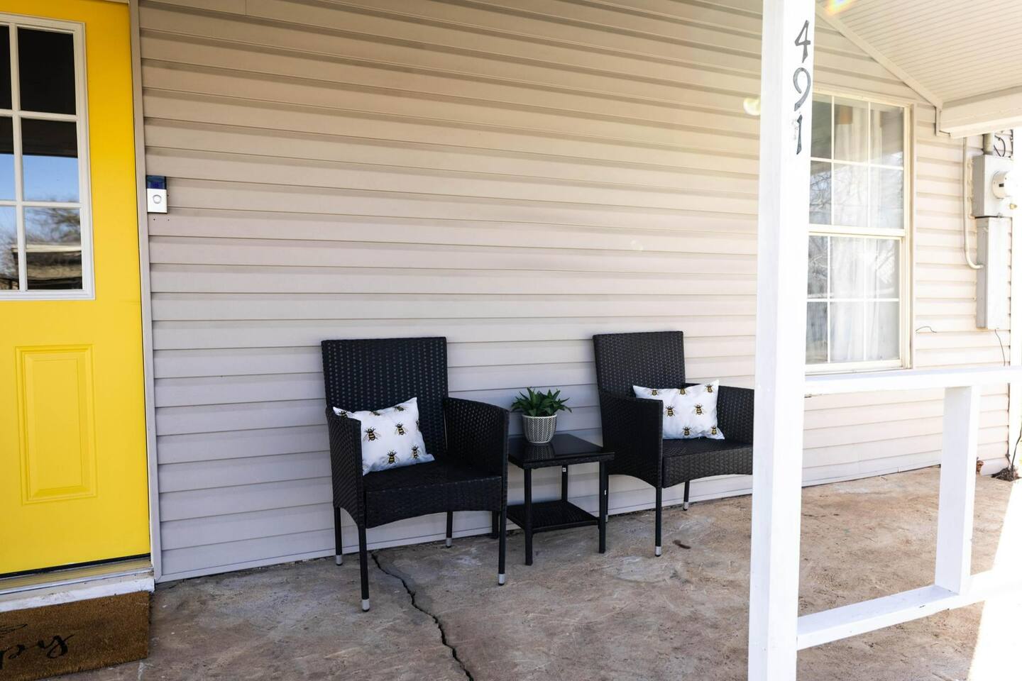 Relax on the front porch with comfortable seating, perfect for enjoying morning coffee or evening sunsets.