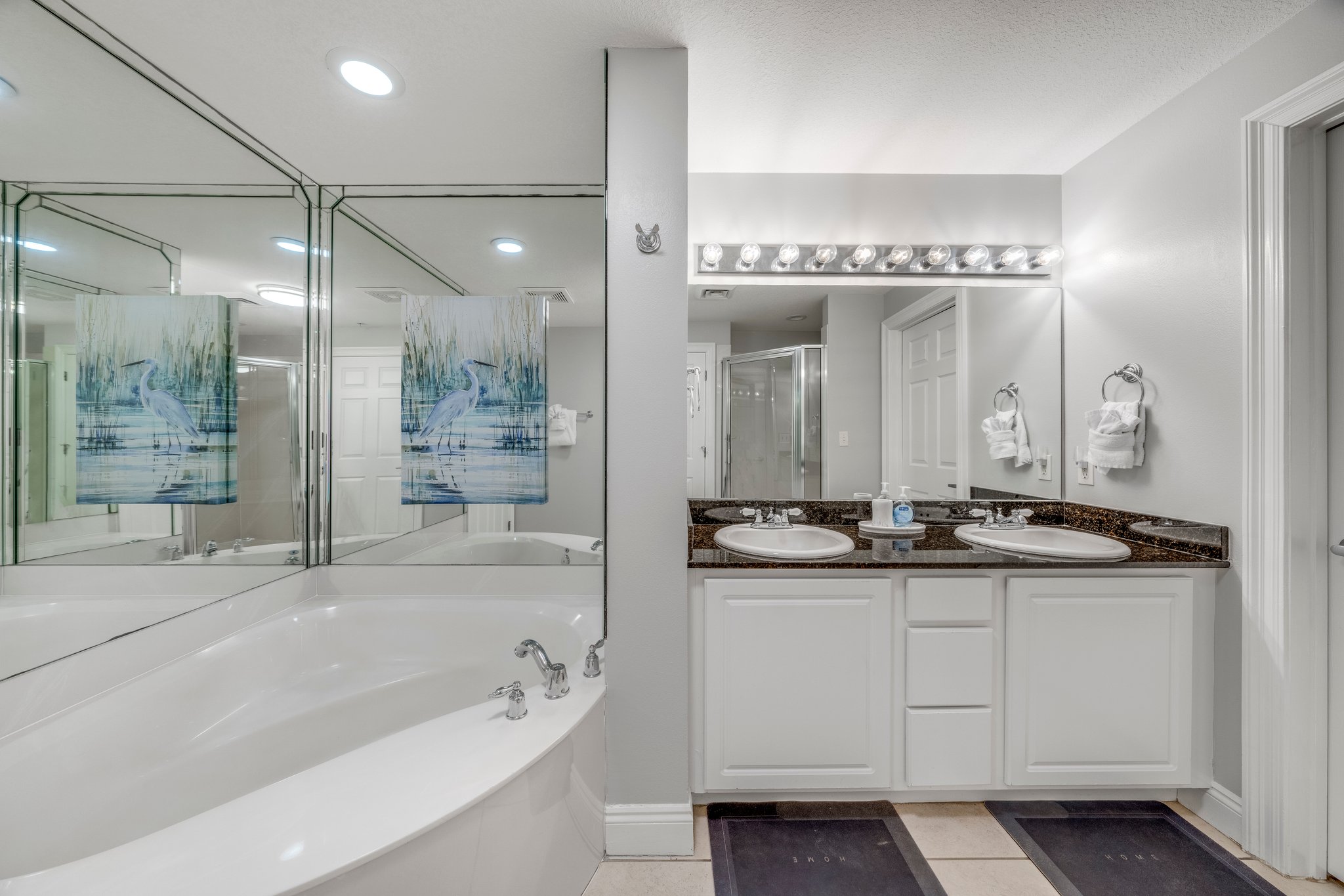 Large tub and walk-in shower with dual vanities