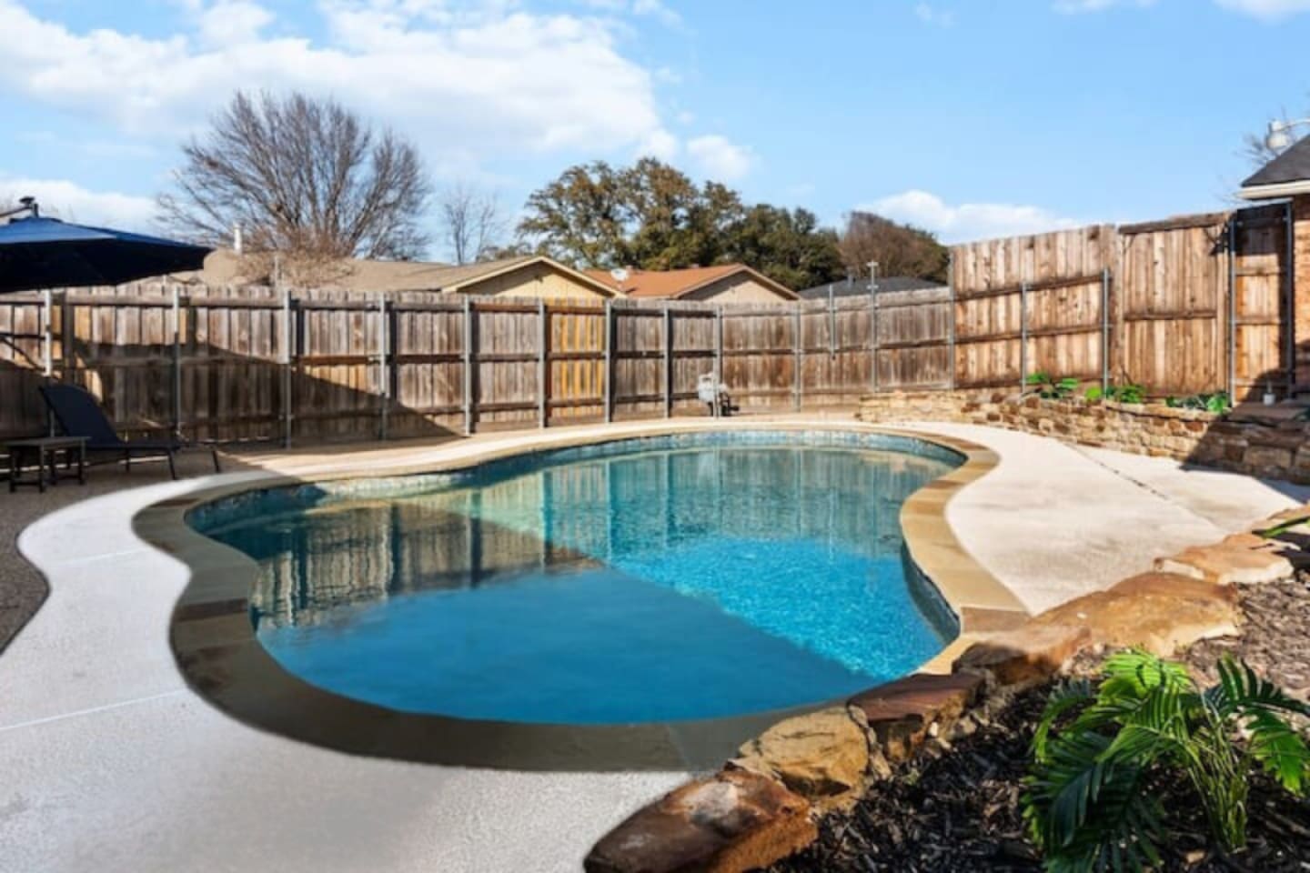 Dive into the large backyard pool, offering a private oasis for guests to cool off and enjoy the sun.
