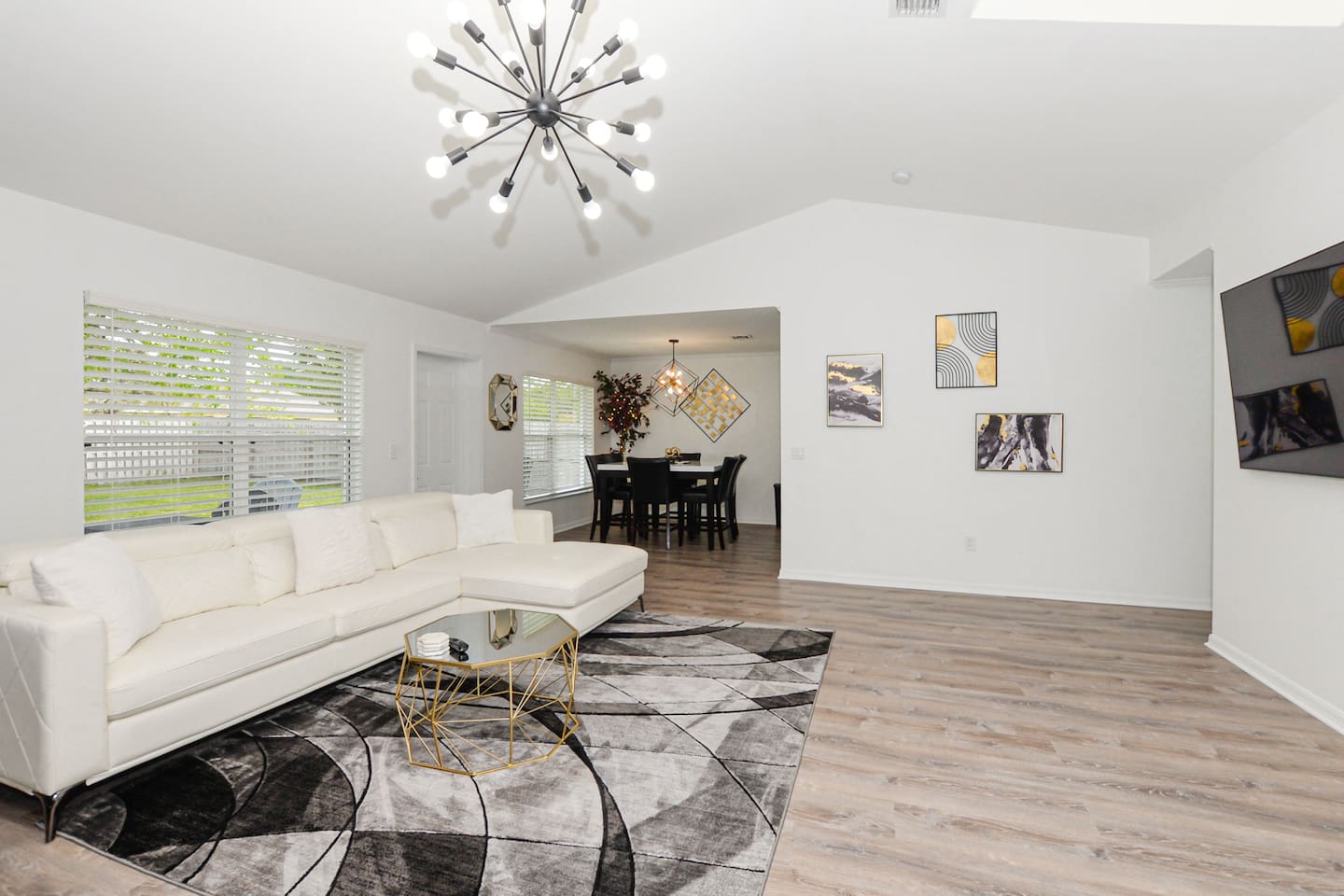 Spacious living room with a cozy couch positioned perfectly in front of the TV for ultimate relaxation.