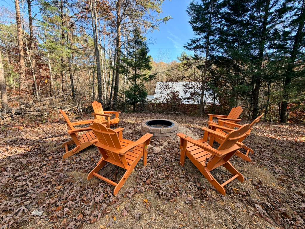 Gather 'round! Our custom stone fire pit and bright orange chairs are ready for s'mores and evening mountain stories.