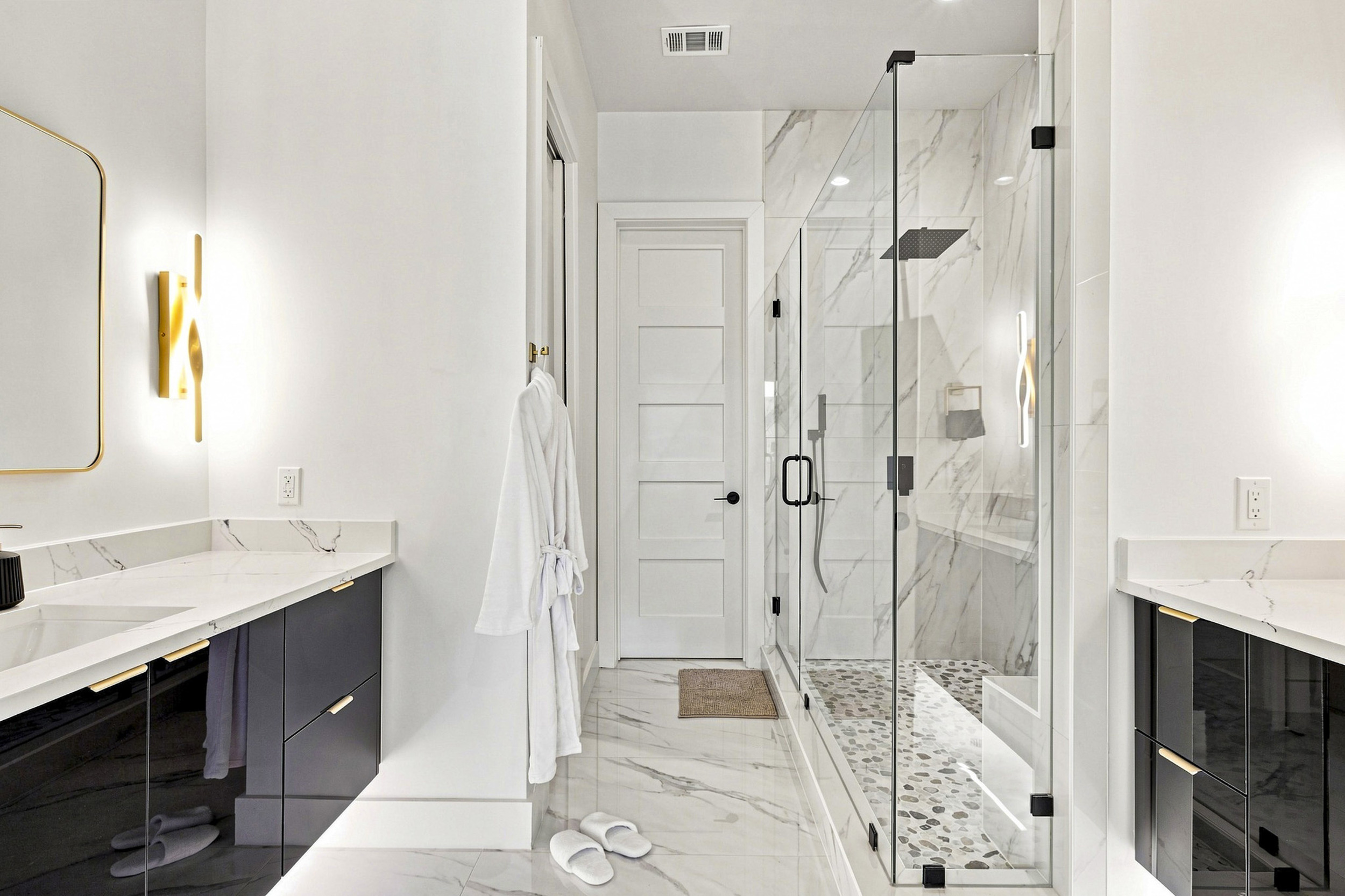 Indulge in elegance with marble finishes and a spacious, glass-enclosed shower!
