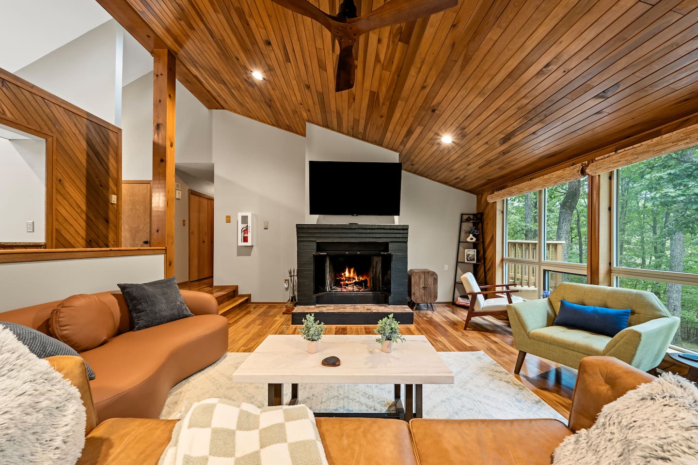Overlooking the woods outside, the living room feels like a treehouse you don't have to sacrifice any comfort.  Plenty of seating for your whole group and the whole room drips with mid-century modern flair.
