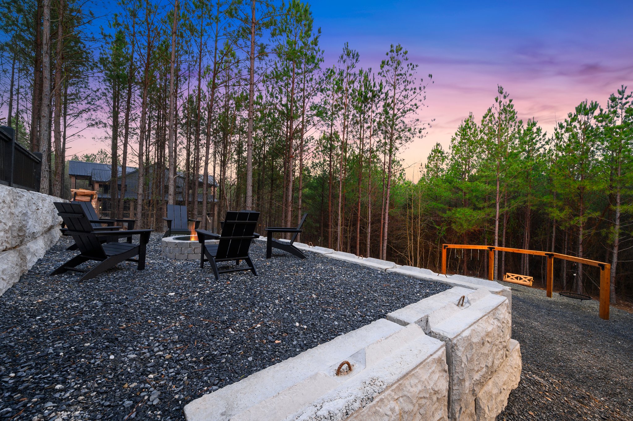 Gather around the firepit under the evening sky and enjoy cozy nights surrounded by the woods.