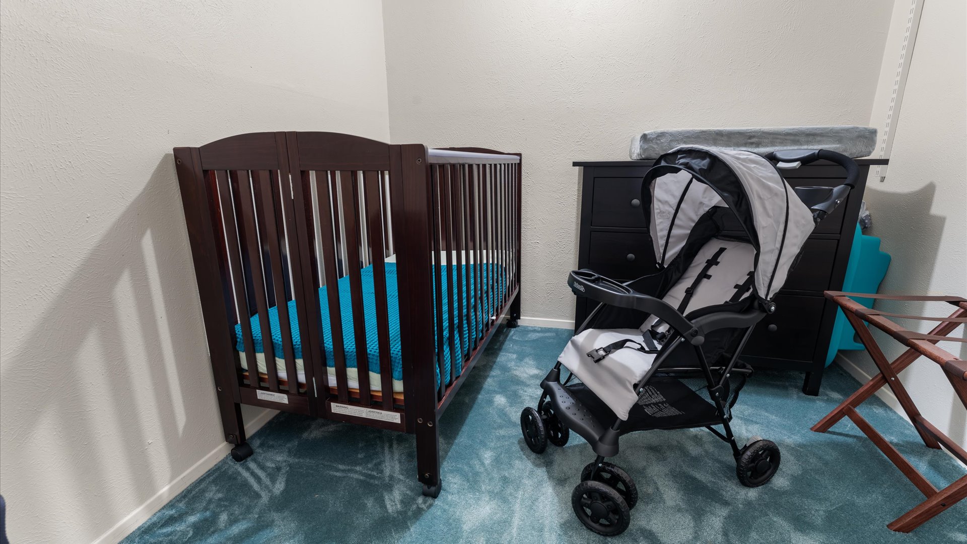 King Bedroom 2 is perfect for guests traveling with little ones! It includes a dedicated baby-friendly space with a crib, changing station, stroller, and a Pack 'n Play.