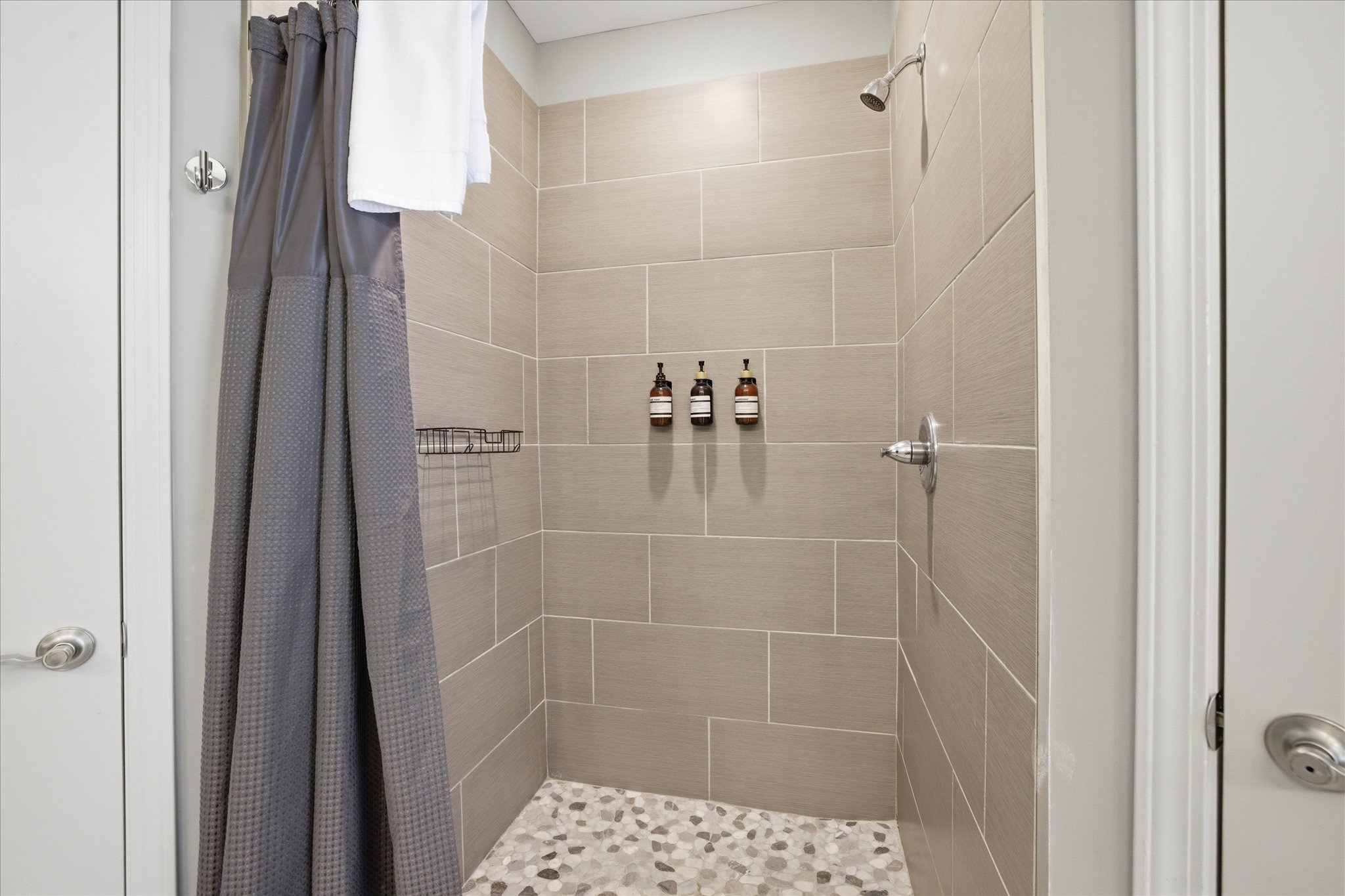 Step into the walk-in stone shower and reset. It’s spacious, simple, and designed to feel like a quiet moment after a full day out.