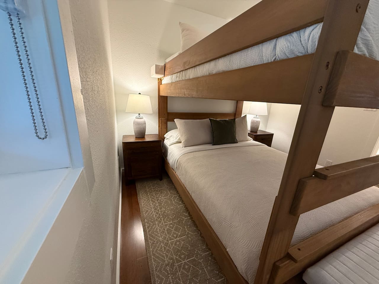 Nightstands with a lamp and electrical outlets and USB outlets on either side of the bed. 