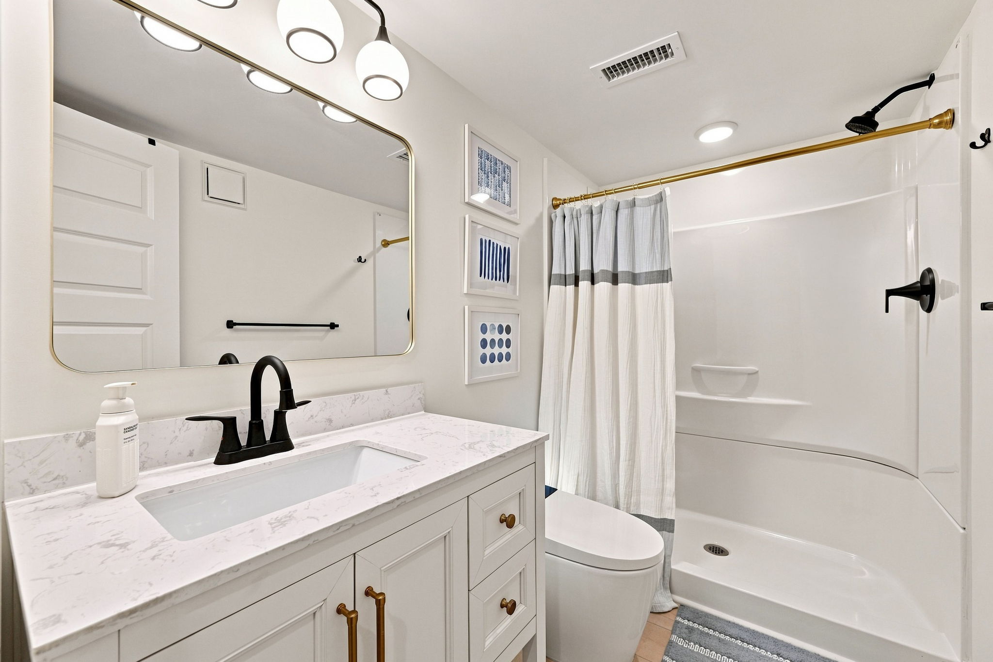 A fresh, modern full bath perfectly positioned for easy access from the living areas and bedrooms.
